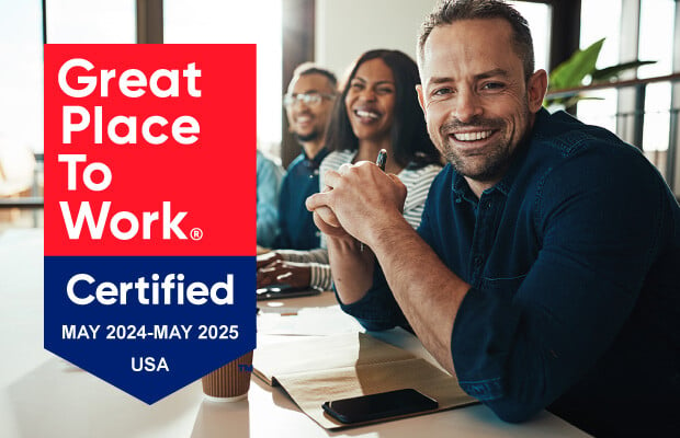 Three smiling people at a meeting with Great Place to Work Certified May 2024-May 2025 USA graphic.
