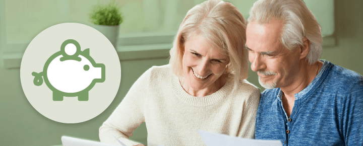 An elderly couple reading papers together.