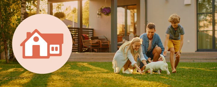 Family playing with a small white dog in a backyard near a house. There is a house icon graphic on the left.